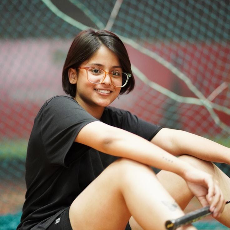 Kaveri Mehta, Lead Design Curator at HarborCrestMoss, reviewing corporate floral arrangements